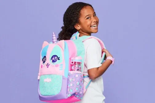 Girl wearing a cat unicorn bag