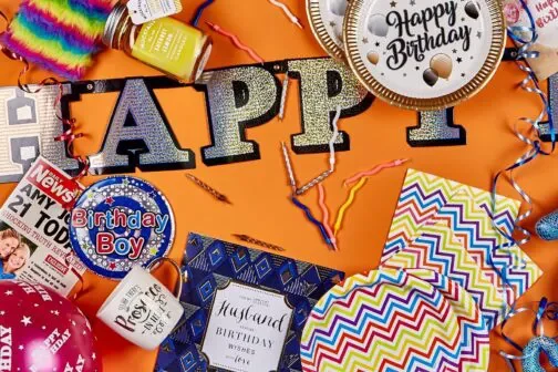 Cards, Birthday badges, party plates and cards on an orange background