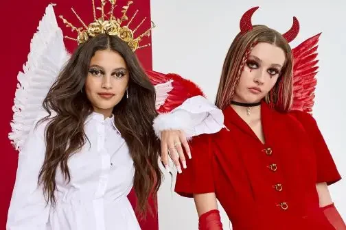 One woman wearing angel costume and one wearing devil costume